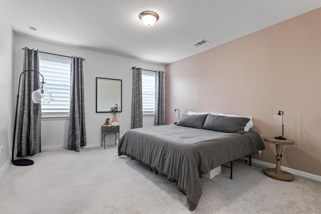 1561 William Way Dallas, TX 75234 - Photo 20 of 38 a bedroom with a bed and a table