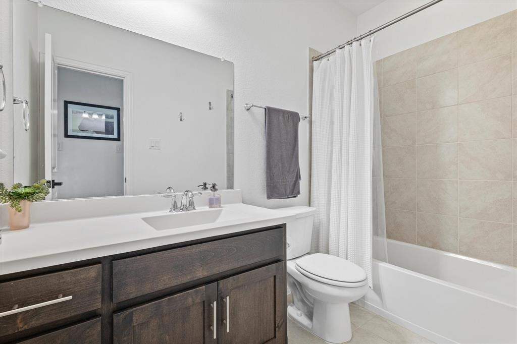 1561 William Way Dallas, TX 75234 - Photo 21 of 38 a bathroom with a sink a toilet and shower