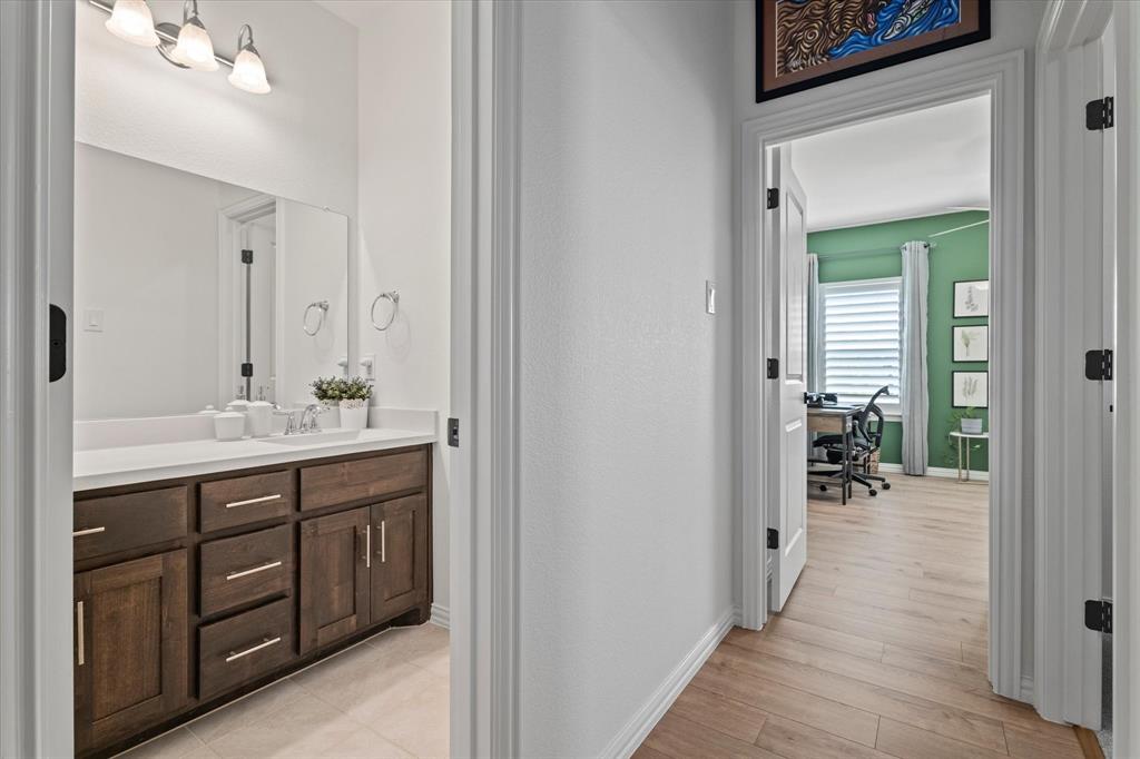 1561 William Way Dallas, TX 75234 - Photo 22 of 38 a bathroom with a sink and mirror