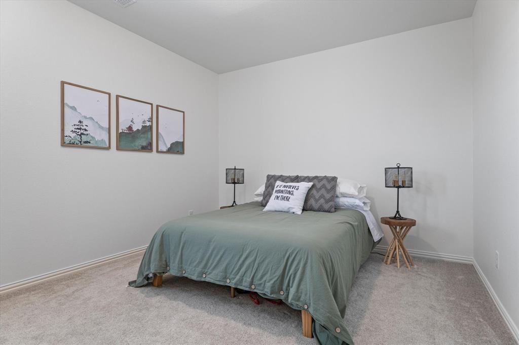 1561 William Way Dallas, TX 75234 - Photo 24 of 38 a bedroom with a bed and a lamp on the dresser