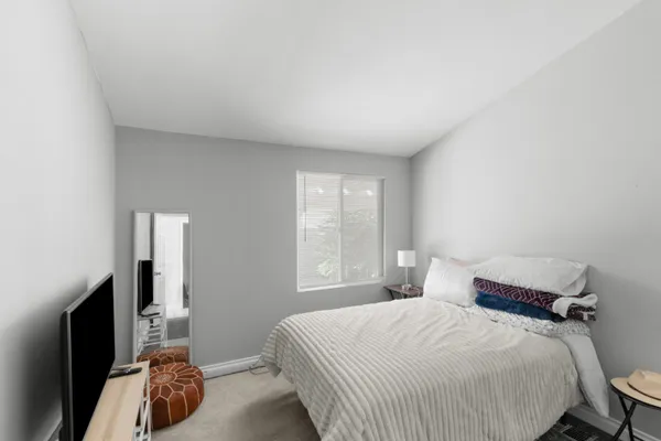 a bedroom with a bed and a window