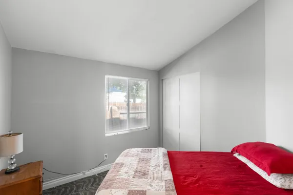 a bedroom with a bed and a window