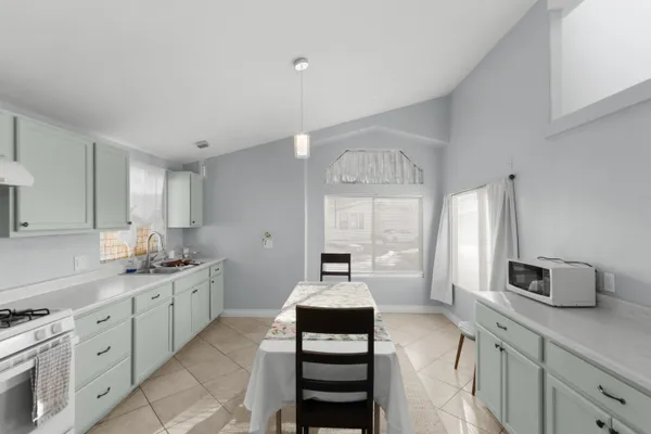 a kitchen with a sink stove and cabinets
