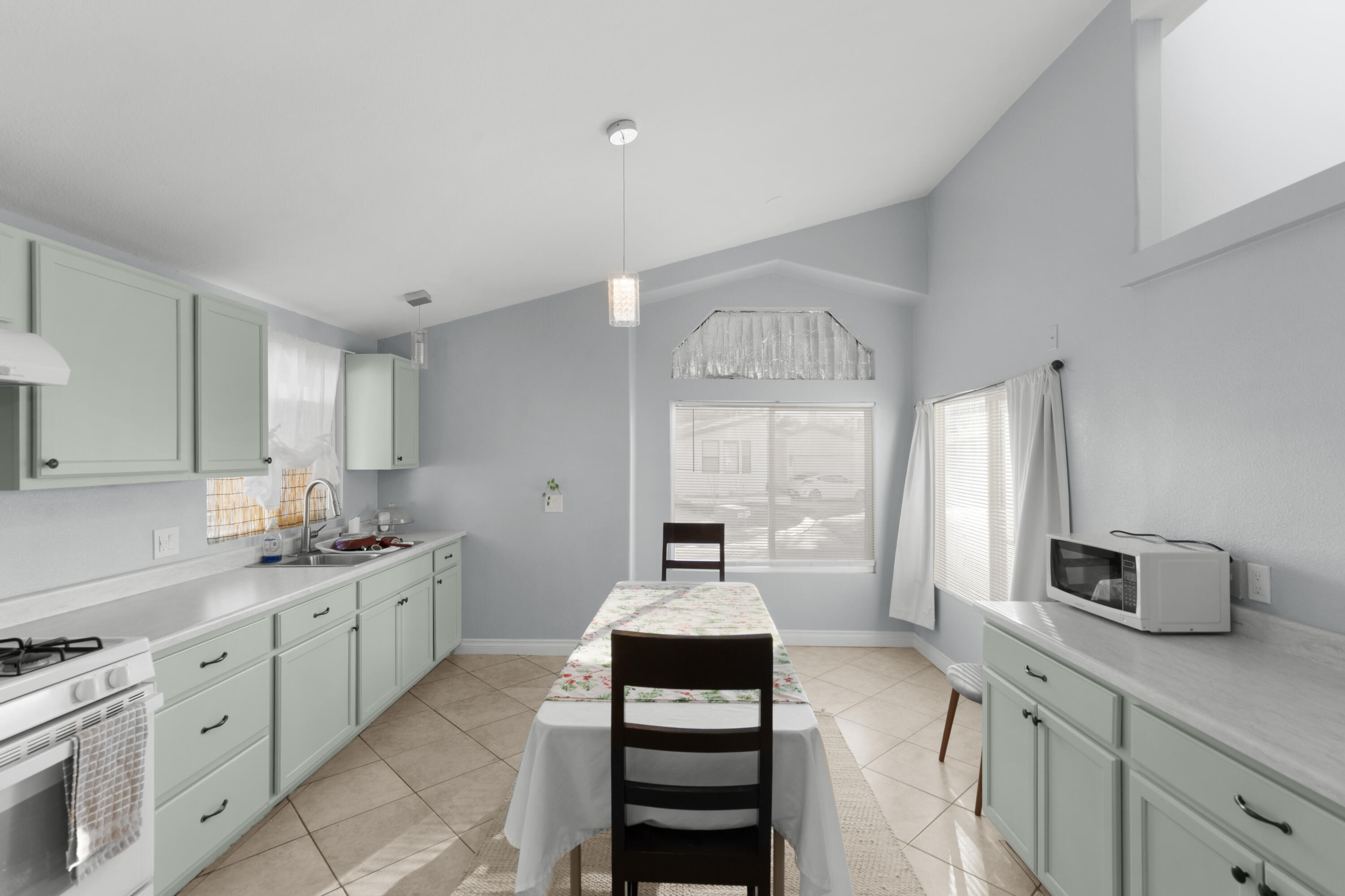 47800 Madison Street, Unit 44 Indio, CA 92201 - Photo 23 of 25 a kitchen with a sink stove and cabinets