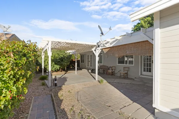 a view of a house with backyard and sitting area