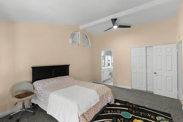 a bedroom with a bed and a chandelier