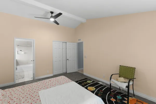 a bedroom with a bed and a chair