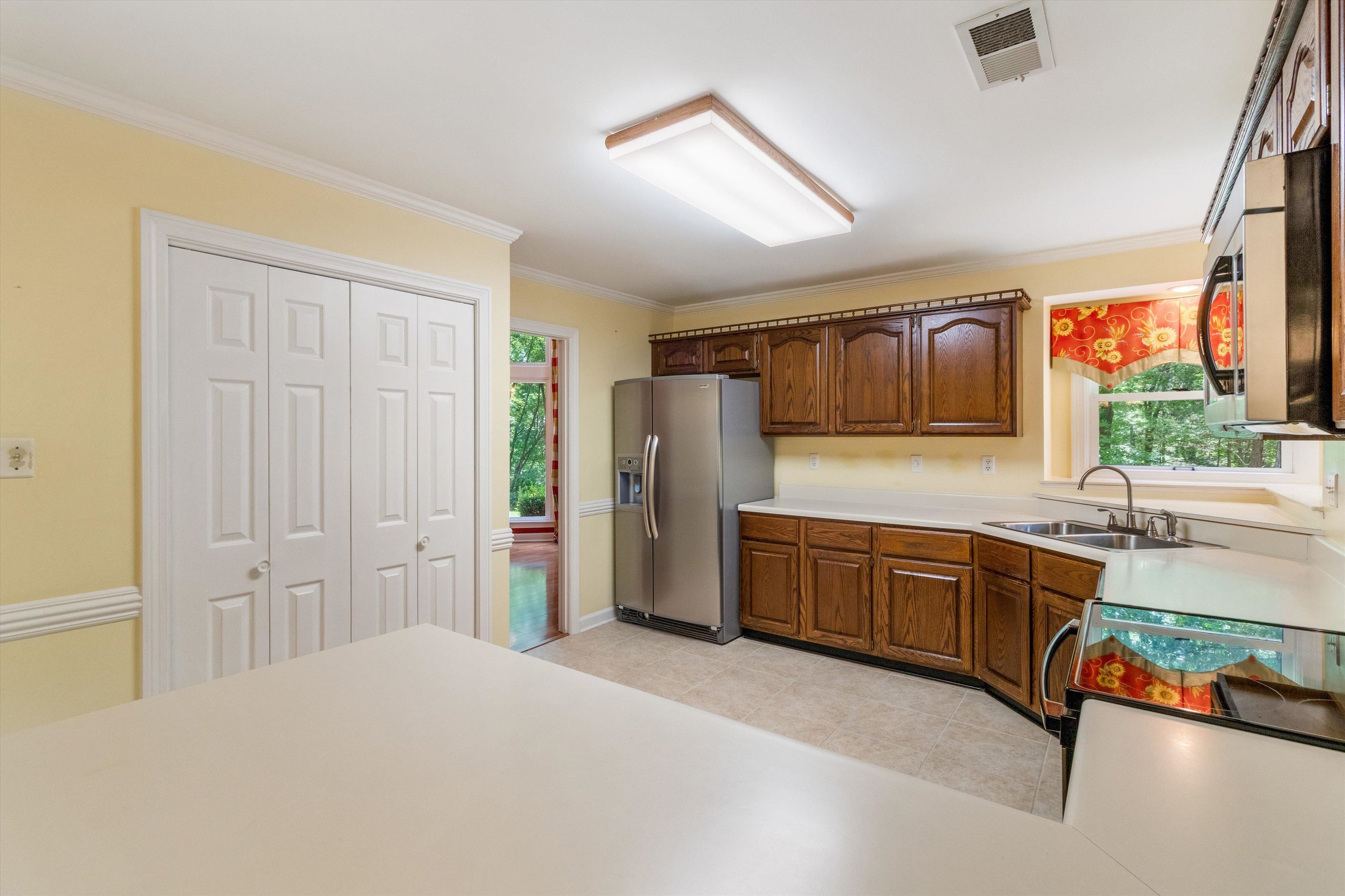 4081 Brunswick Road Bartlett, TN 38133 - Photo 12 of 31 Kitchen with appliances with stainless steel finishes, healthy amount of natural light, crown molding, and light countertops