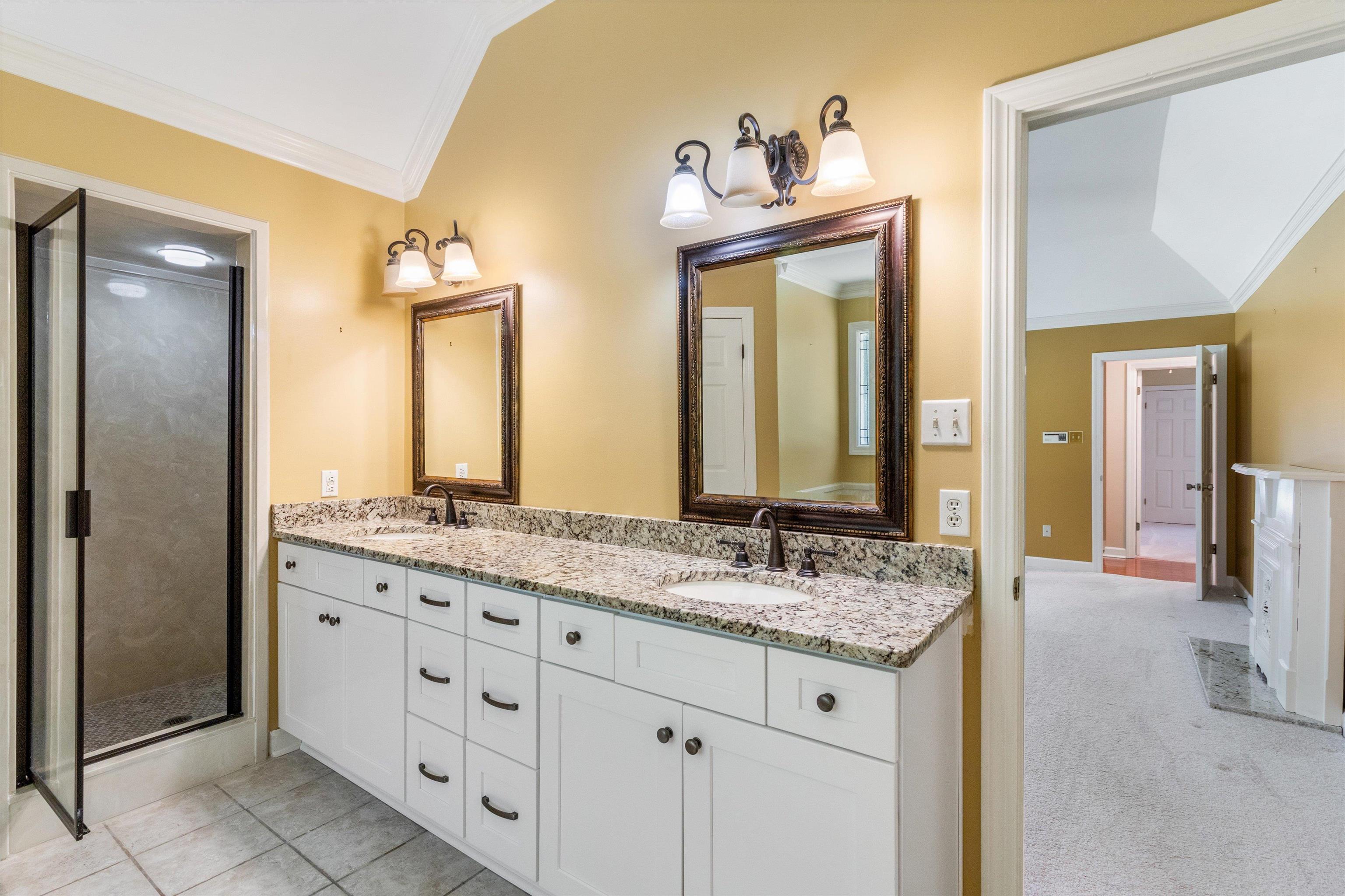 4081 Brunswick Road Bartlett, TN 38133 - Photo 19 of 31 Full bath featuring ornamental molding, double vanity, vaulted ceiling, and a stall shower