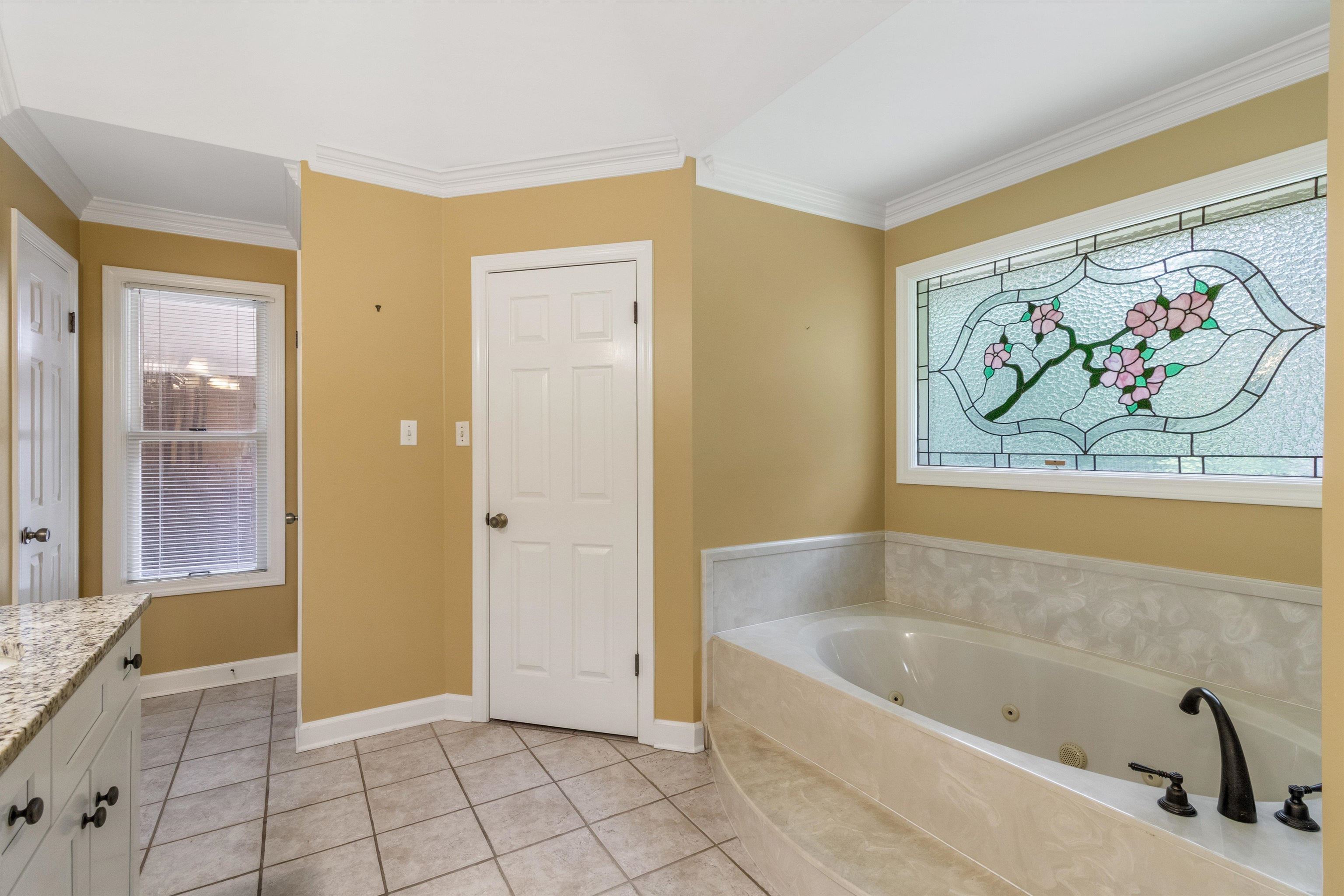 4081 Brunswick Road Bartlett, TN 38133 - Photo 20 of 31 Bathroom featuring vanity, a tub with jets, ornamental molding, plenty of natural light, and tile patterned flooring