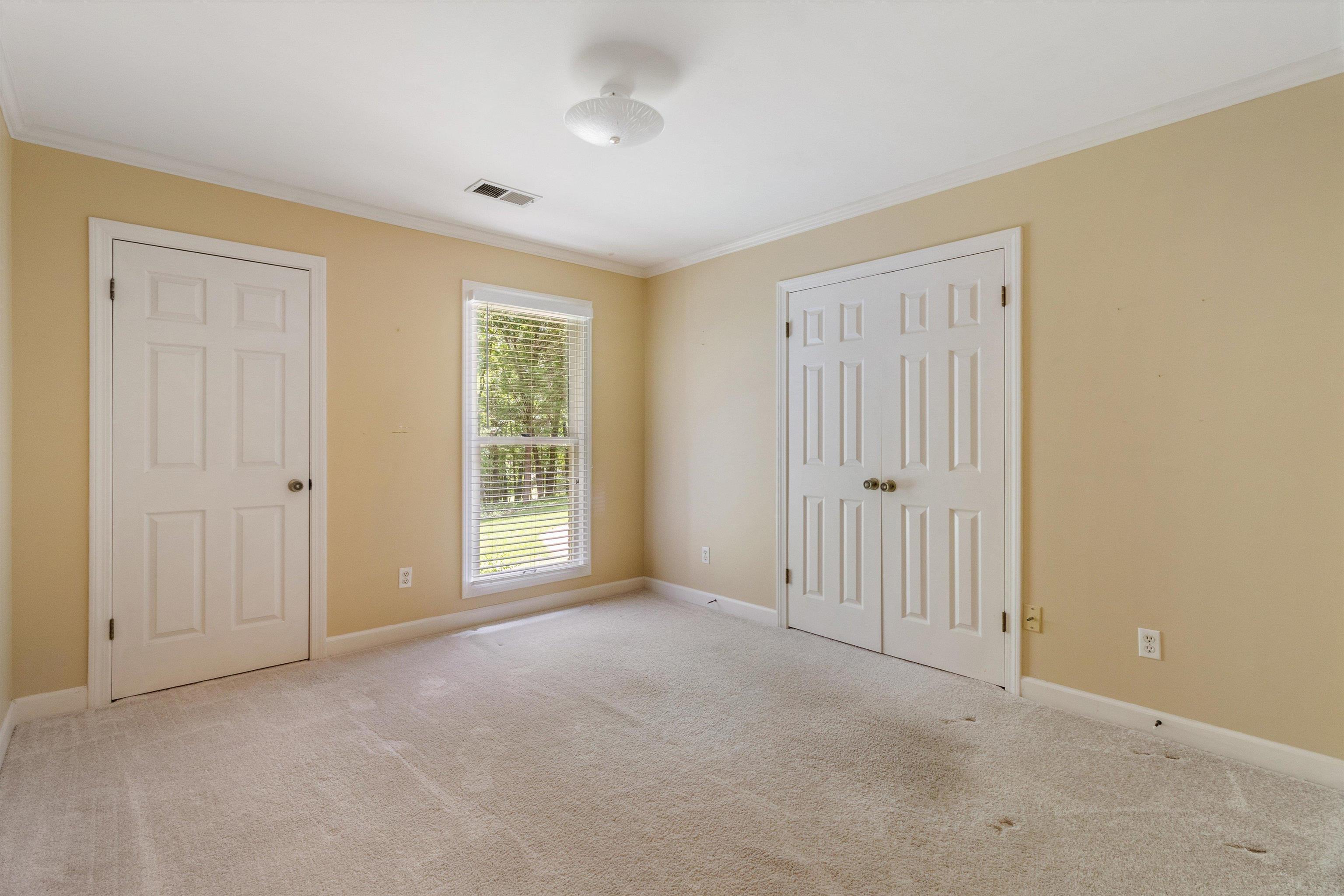 4081 Brunswick Road Bartlett, TN 38133 - Photo 21 of 31 Unfurnished bedroom with ornamental molding, carpet flooring, and a closet