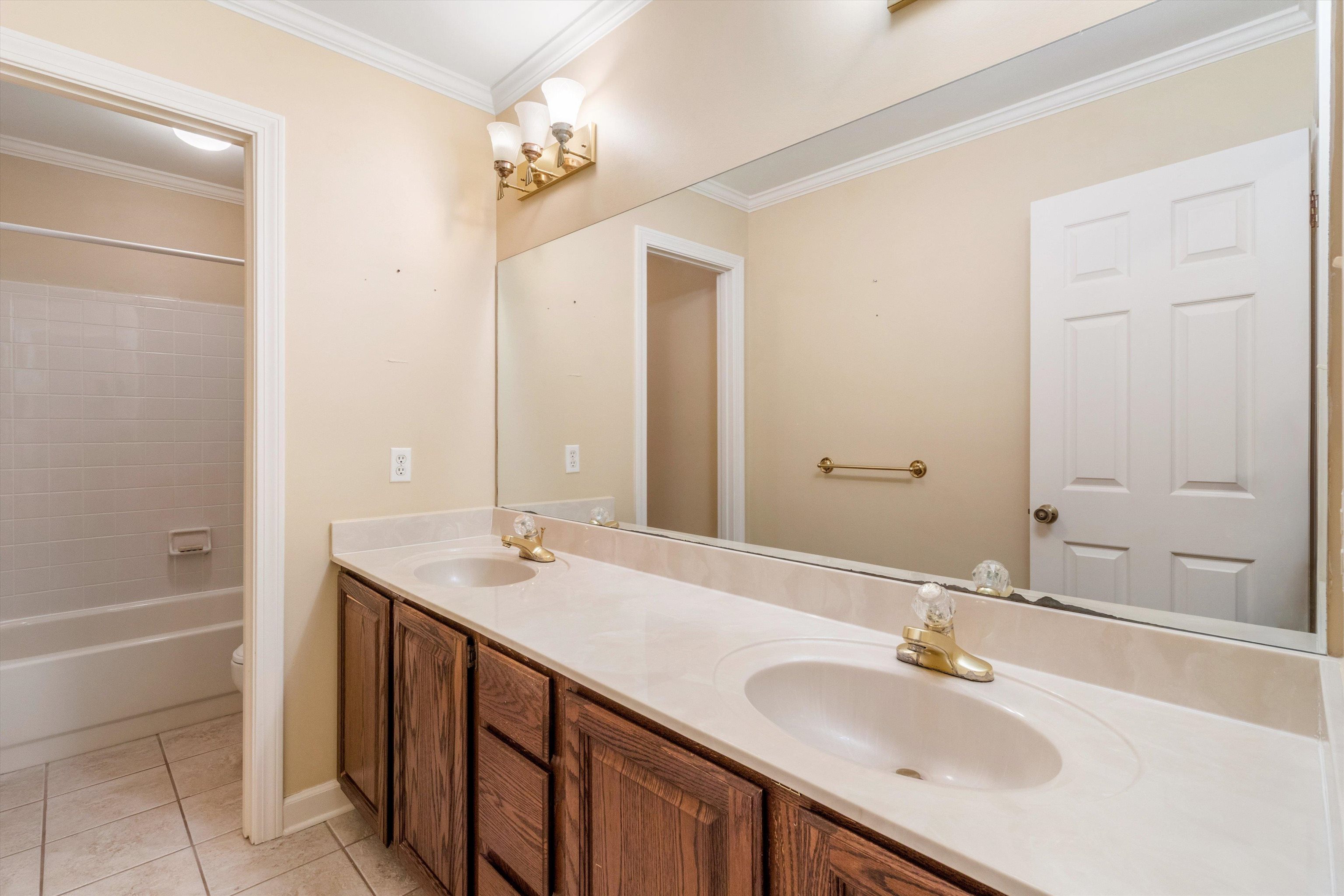 4081 Brunswick Road Bartlett, TN 38133 - Photo 22 of 31 Bathroom featuring double vanity, tile patterned flooring, ornamental molding, and shower combination