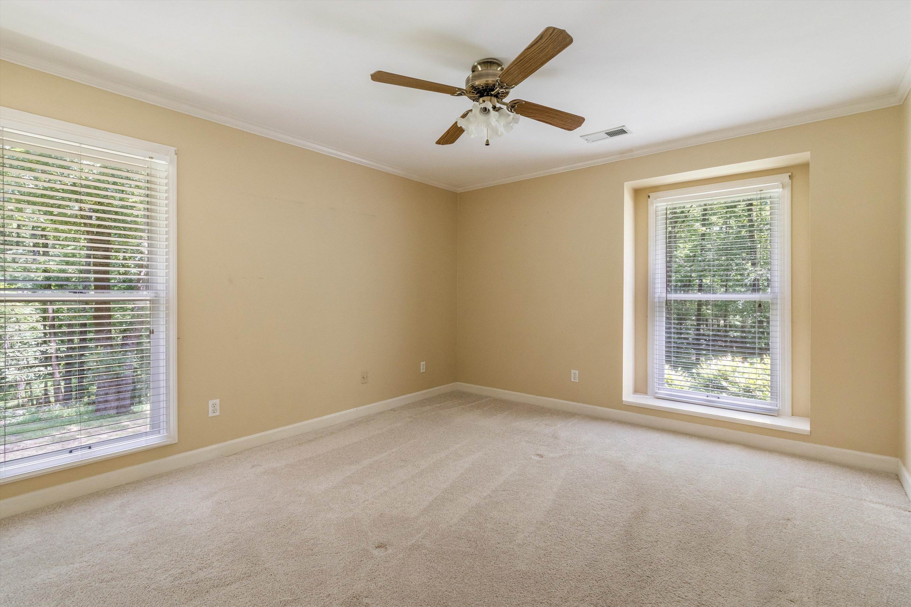 4081 Brunswick Road Bartlett, TN 38133 - Photo 23 of 31 Empty room with ornamental molding, light colored carpet, and a ceiling fan