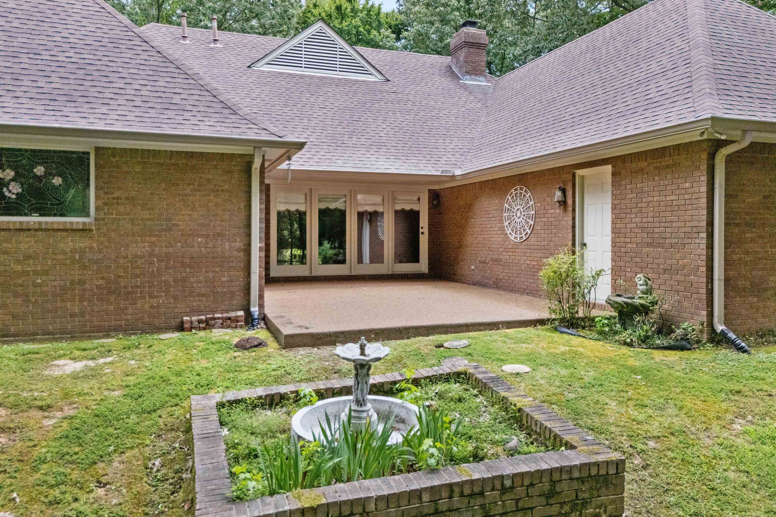 4081 Brunswick Road Bartlett, TN 38133 - Photo 27 of 31 Rear view of house with a patio area, a yard, a chimney, and a shingled roof