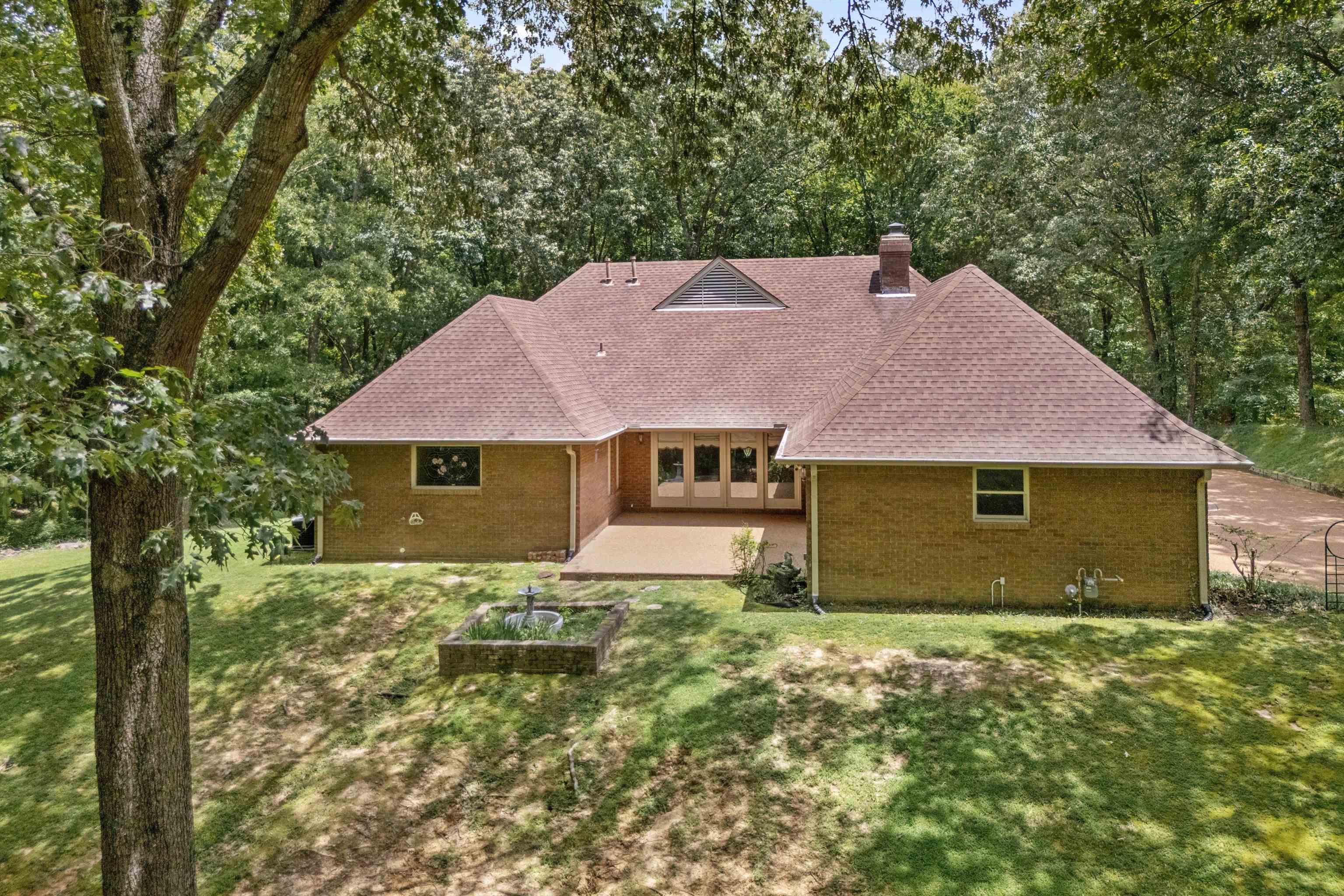 4081 Brunswick Road Bartlett, TN 38133 - Photo 28 of 31 Rear view of house featuring a patio area, roof with shingles, a lawn, a chimney, and brick siding