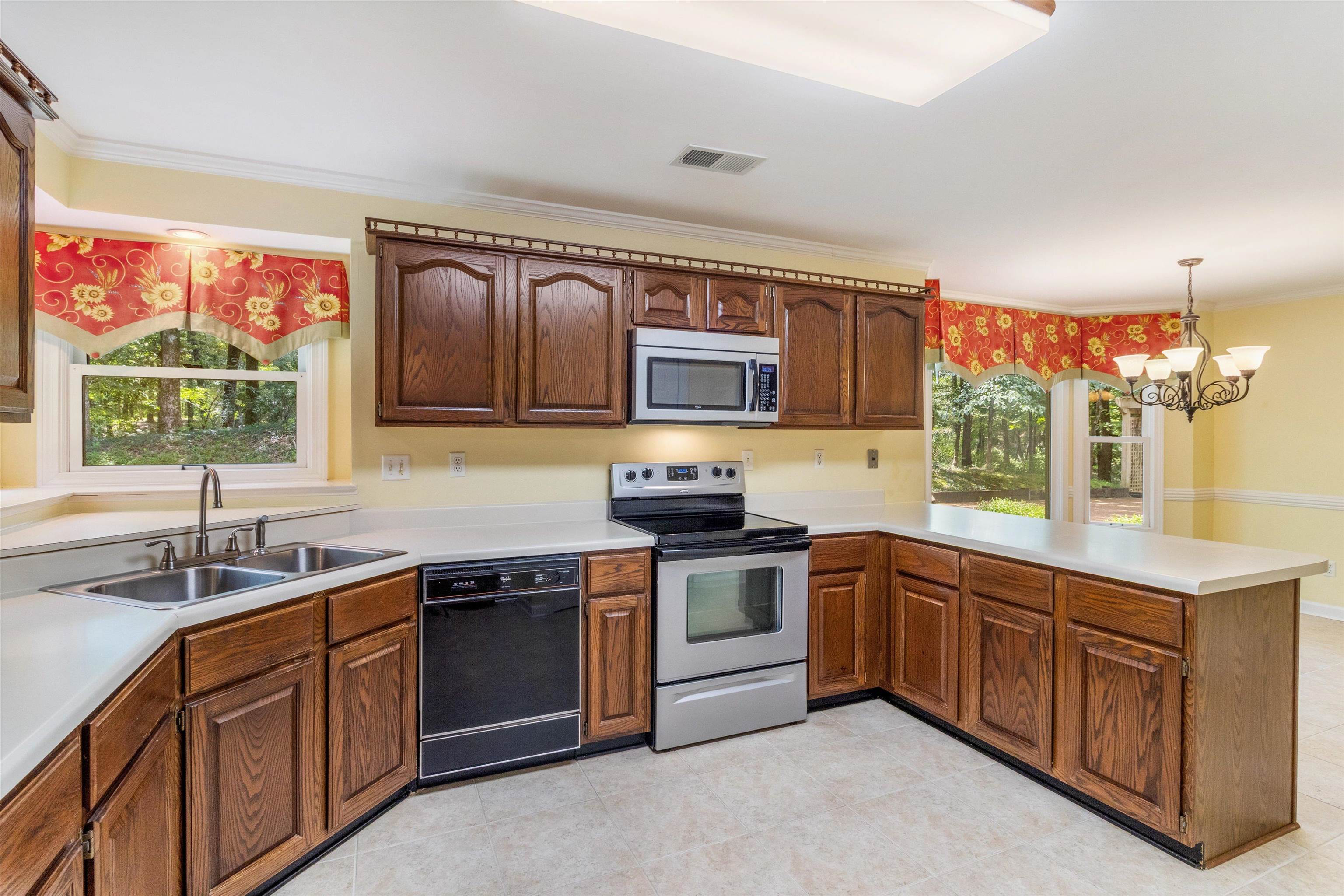 4081 Brunswick Road Bartlett, TN 38133 - Photo 10 of 31 Kitchen with stainless steel appliances, a peninsula, crown molding, healthy amount of natural light, and light countertops