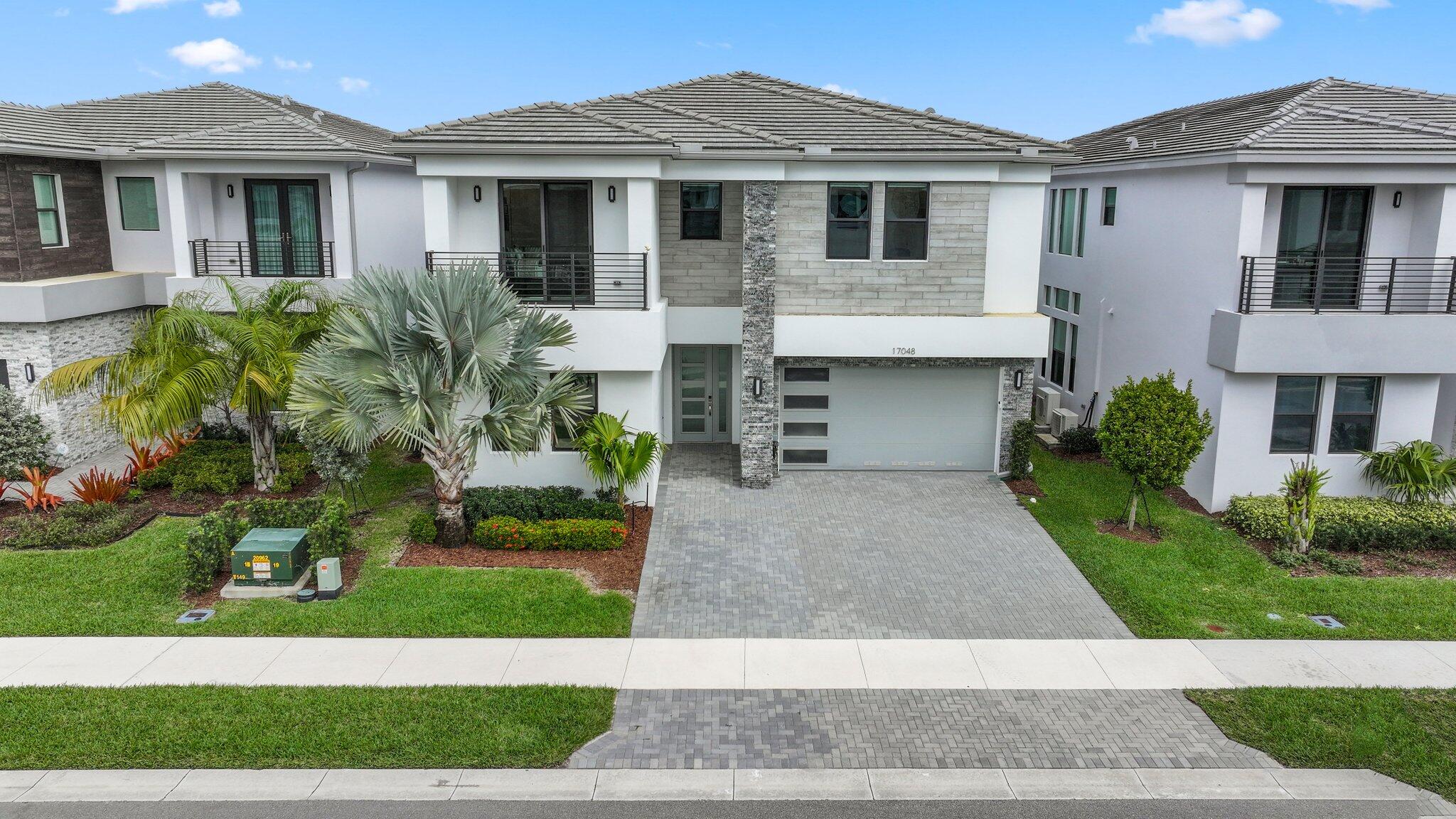 17048 Teton River Road Boca Raton, FL 33496 - Photo 3 of 69 a front view of a house with a yard and garage