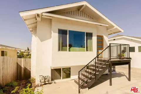 a front view of a house with wooden stairs