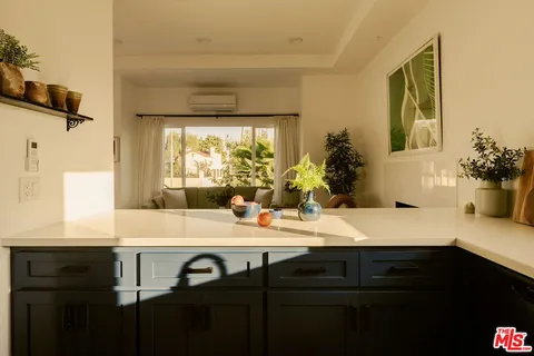 a kitchen with a sink cabinets and dining table