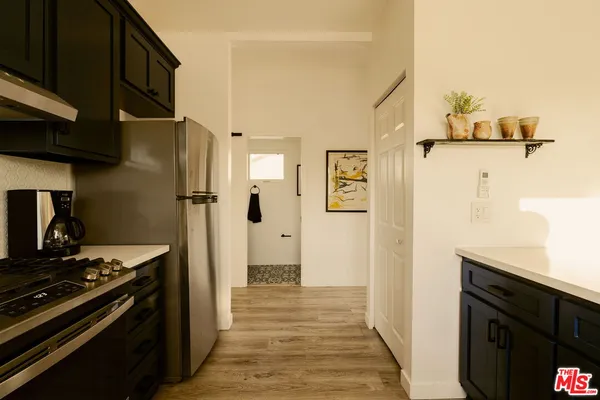 a kitchen with stainless steel appliances a stove and a refrigerator
