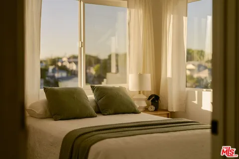 a bedroom with bed and a window