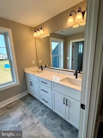 a bathroom with a double vanity sink and a mirror