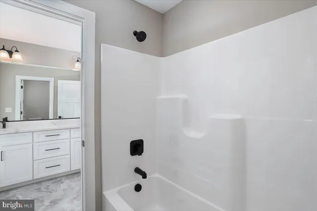 a bathroom with a bathtub and shower