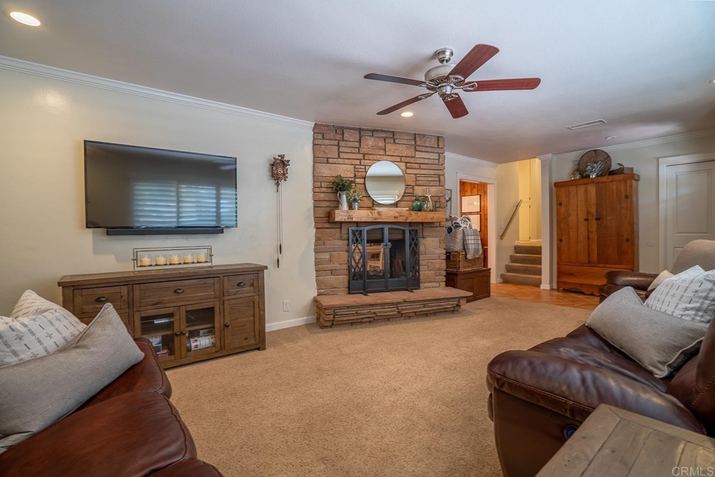11493 Eucalyptus Hills Drive Lakeside, CA 92040 - Photo 15 of 30 a living room with furniture a flat screen tv and a fireplace