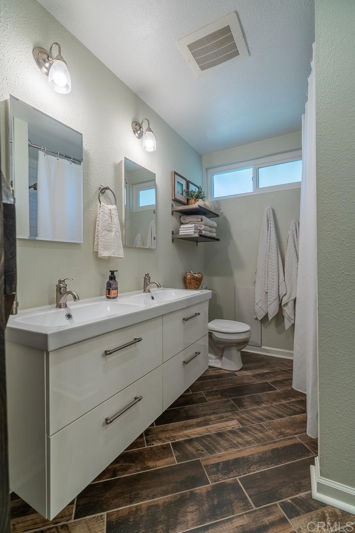 11493 Eucalyptus Hills Drive Lakeside, CA 92040 - Photo 17 of 30 a bathroom with a sink mirror and toilet