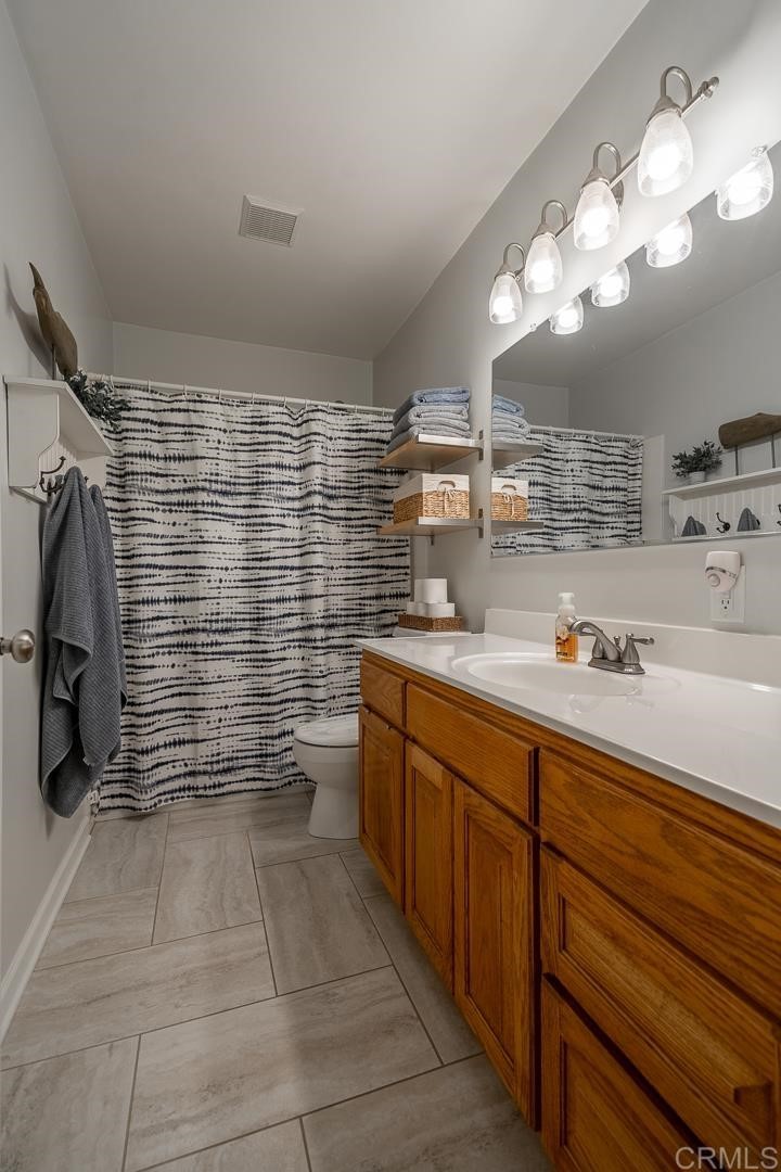 11493 Eucalyptus Hills Drive Lakeside, CA 92040 - Photo 25 of 30 a bathroom with a sink a large mirror and a shower