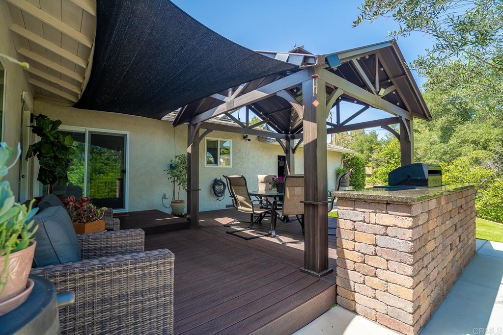 11493 Eucalyptus Hills Drive Lakeside, CA 92040 - Photo 28 of 30 a patio with wooden floor a yard table and chairs
