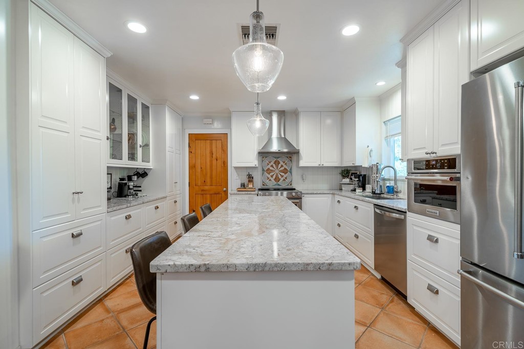 11493 Eucalyptus Hills Drive Lakeside, CA 92040 - Photo 7 of 30 a large kitchen with granite countertop a large counter top appliances and cabinets