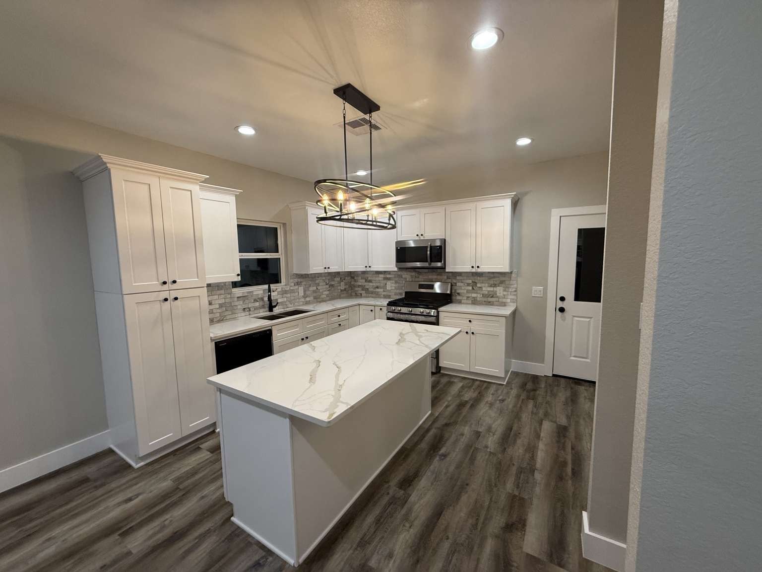 1620 Sam Wilson Street Houston, TX 77020 - Photo 19 of 40 a kitchen with a refrigerator a sink dishwasher a stove and white cabinets with wooden floor