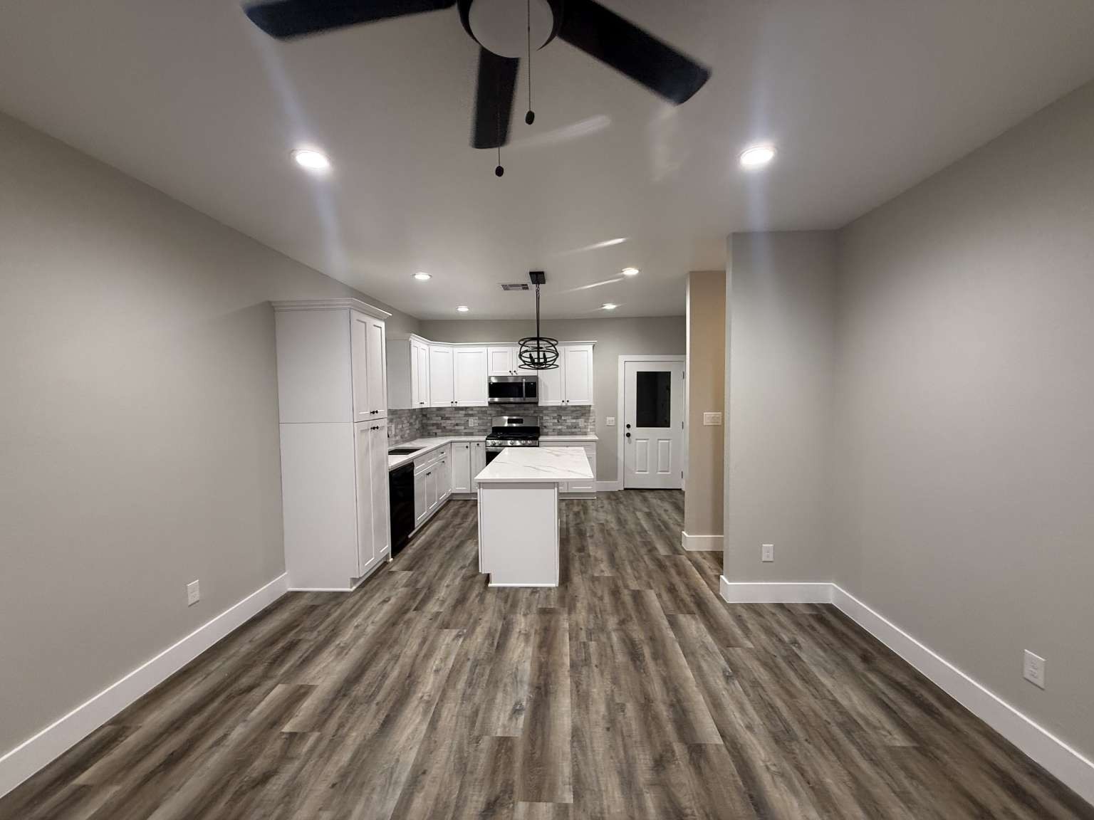 1620 Sam Wilson Street Houston, TX 77020 - Photo 22 of 40 a kitchen with a sink stainless steel appliances wooden floor and view living room