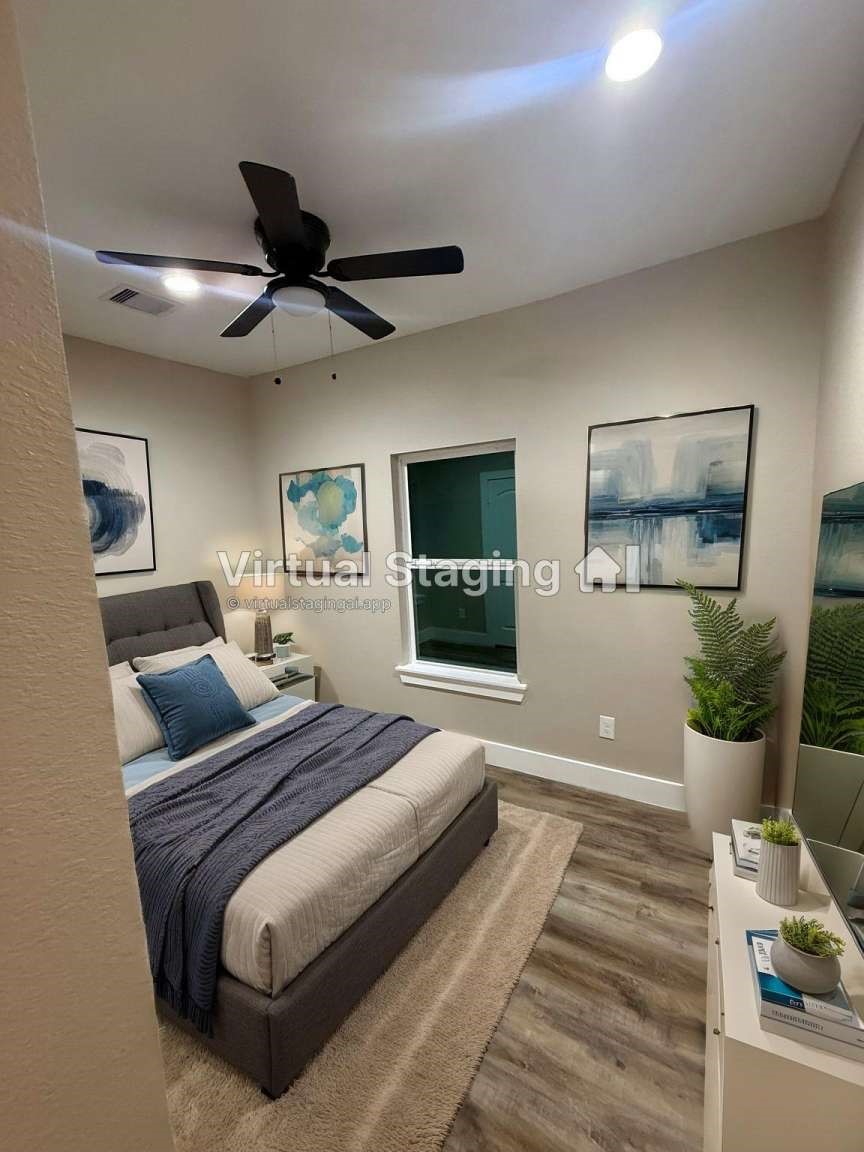 1620 Sam Wilson Street Houston, TX 77020 - Photo 25 of 40 a bedroom with a large bed and a chandelier