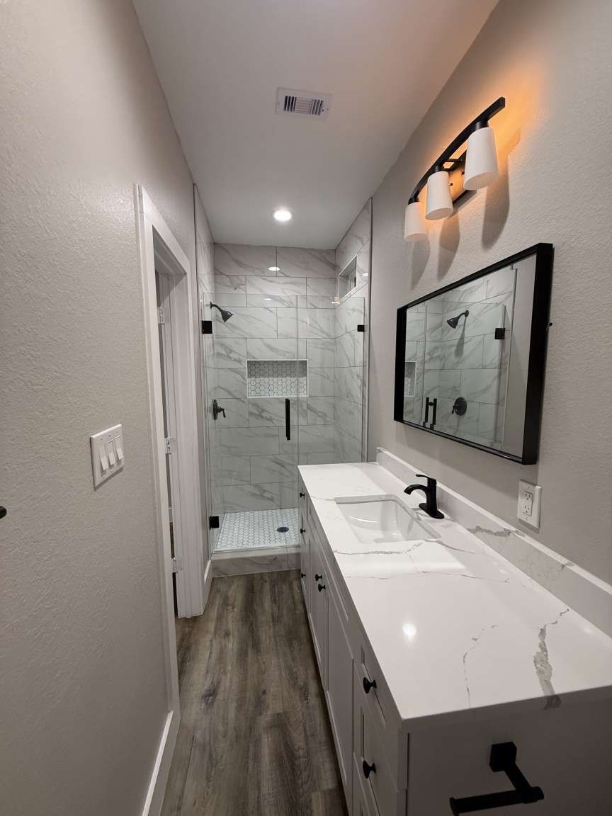 1620 Sam Wilson Street Houston, TX 77020 - Photo 30 of 40 a bathroom with a sink a mirror and shower