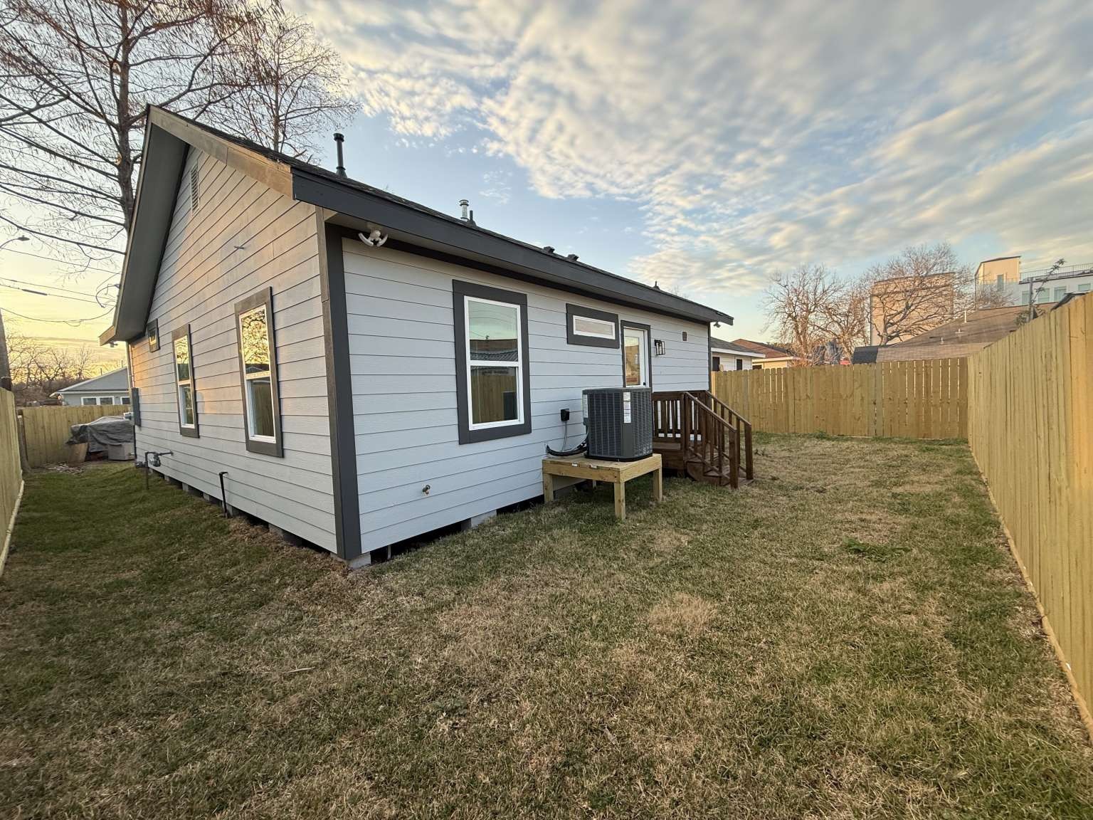 1620 Sam Wilson Street Houston, TX 77020 - Photo 9 of 40 a white house that has a small yard and couches chairs with wooden fence