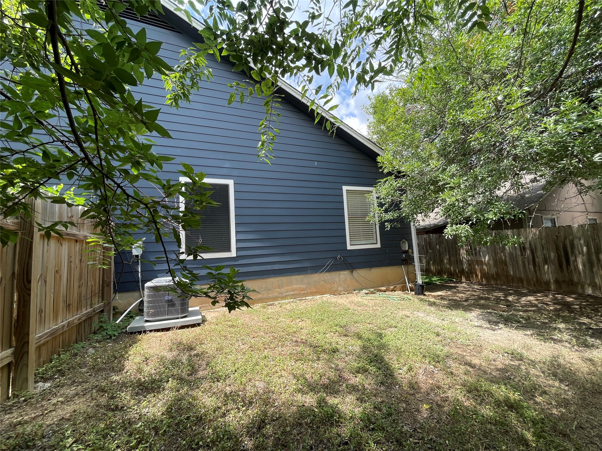 2031 Redwing Way Round Rock, TX 78664 - Photo 24 of 25 Secure yard featuring a wooden privacy fence, perfect for quiet outdoor enjoyment.