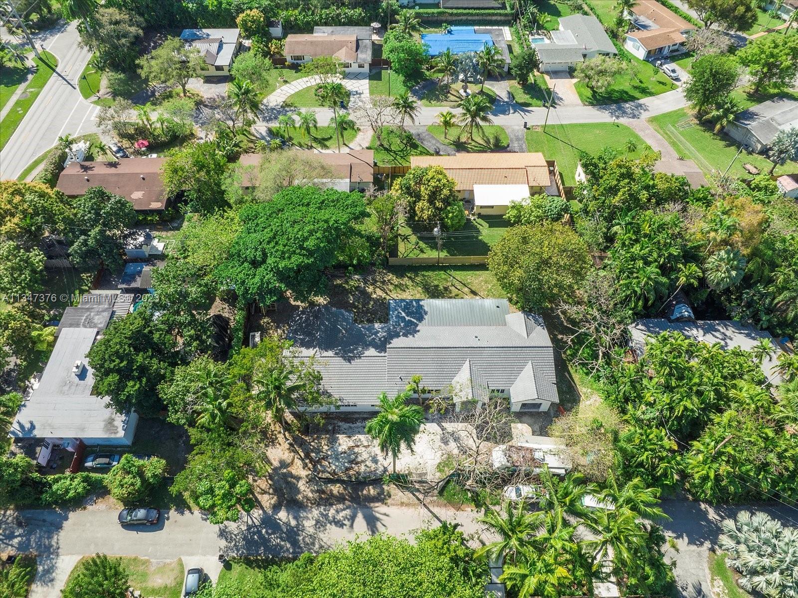 6230 Southwest 60th Street Miami, FL 33143 - Photo 52 of 57 an aerial view of a house with a yard and garden