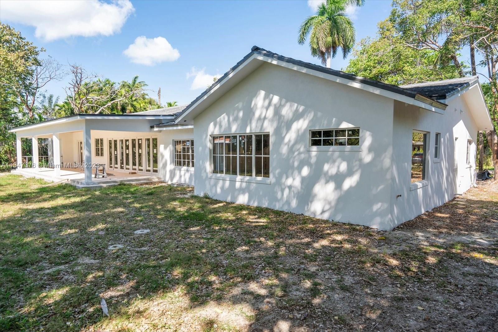 6230 Southwest 60th Street Miami, FL 33143 - Photo 9 of 57 a front view of a house with a yard