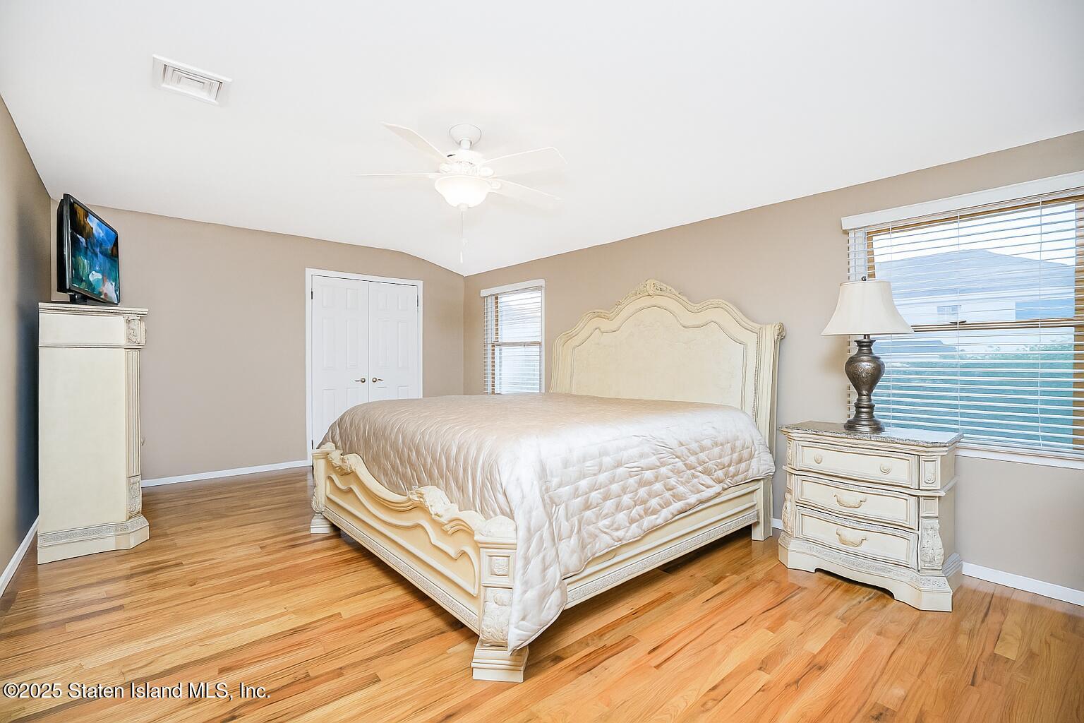 145 Shirley Avenue Staten Island, NY 10312 - Photo 14 of 29 a spacious bedroom with a bed and wooden floor