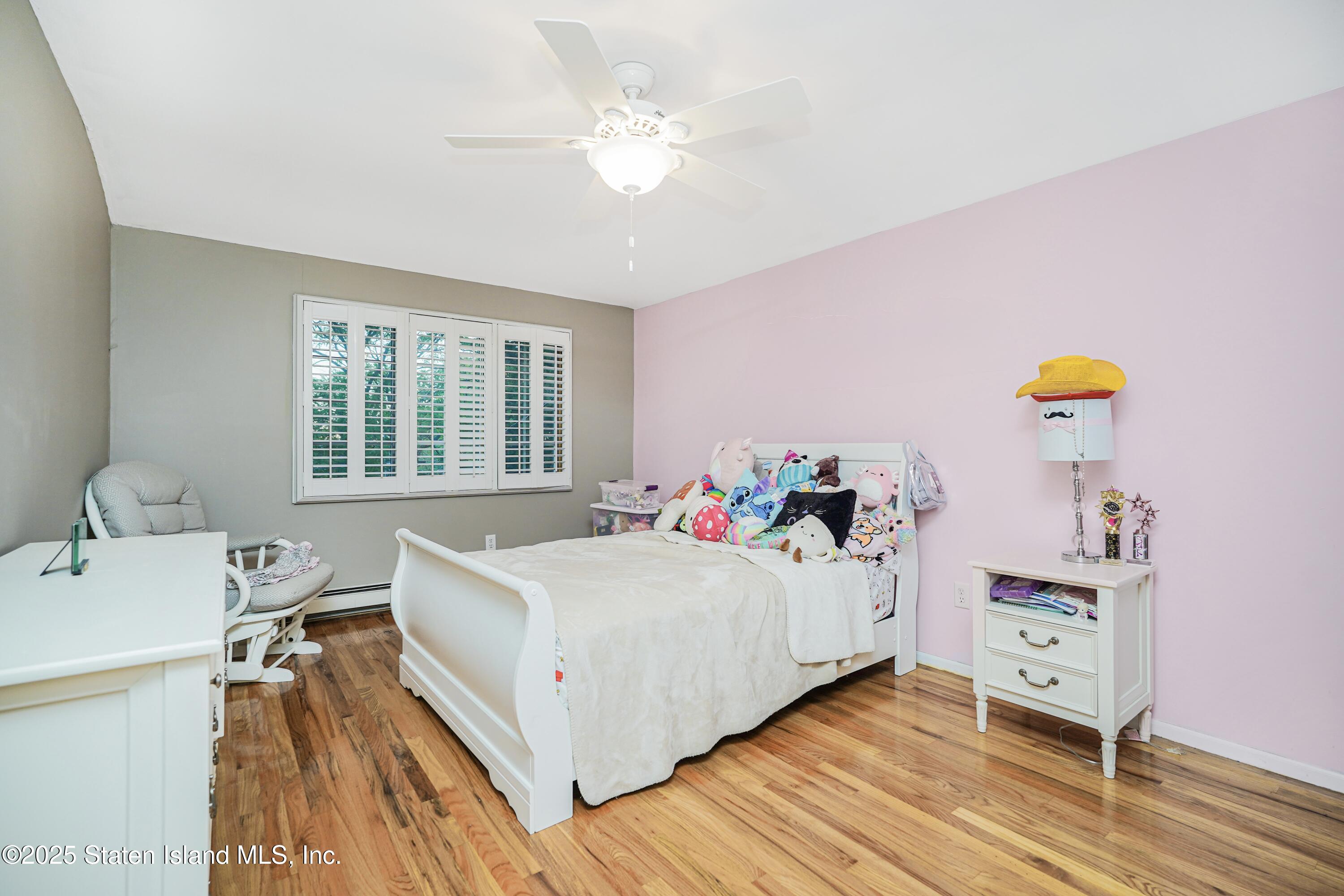 145 Shirley Avenue Staten Island, NY 10312 - Photo 15 of 29 a bedroom with a bed and a dresser