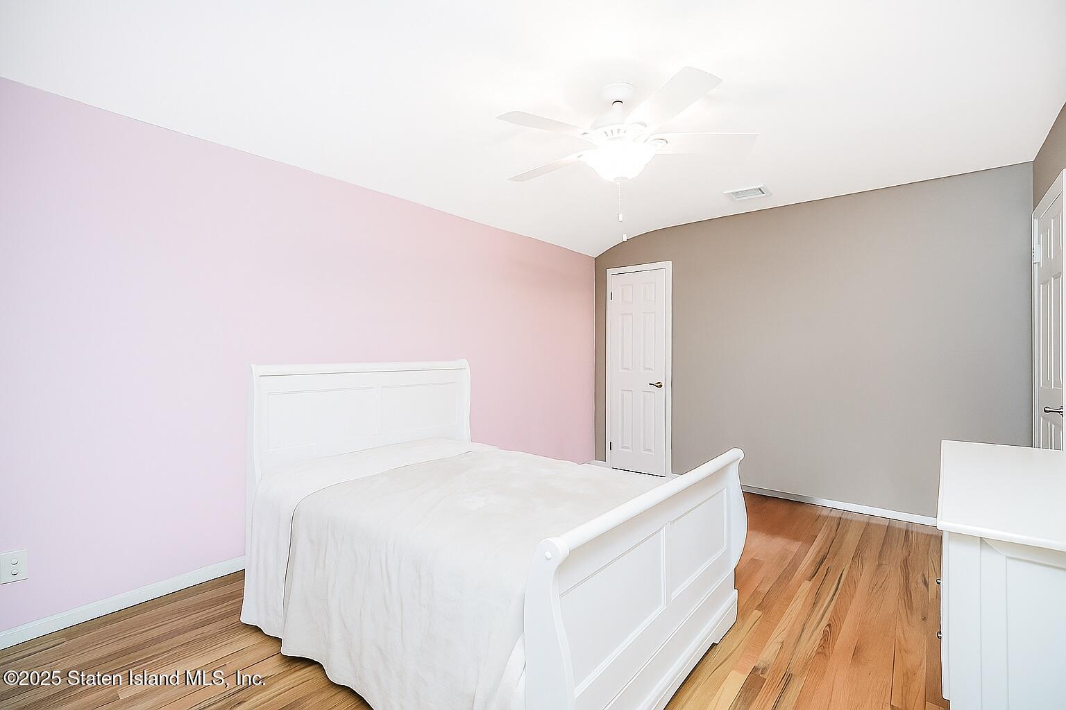 145 Shirley Avenue Staten Island, NY 10312 - Photo 17 of 29 a bedroom with a bed and a night stand