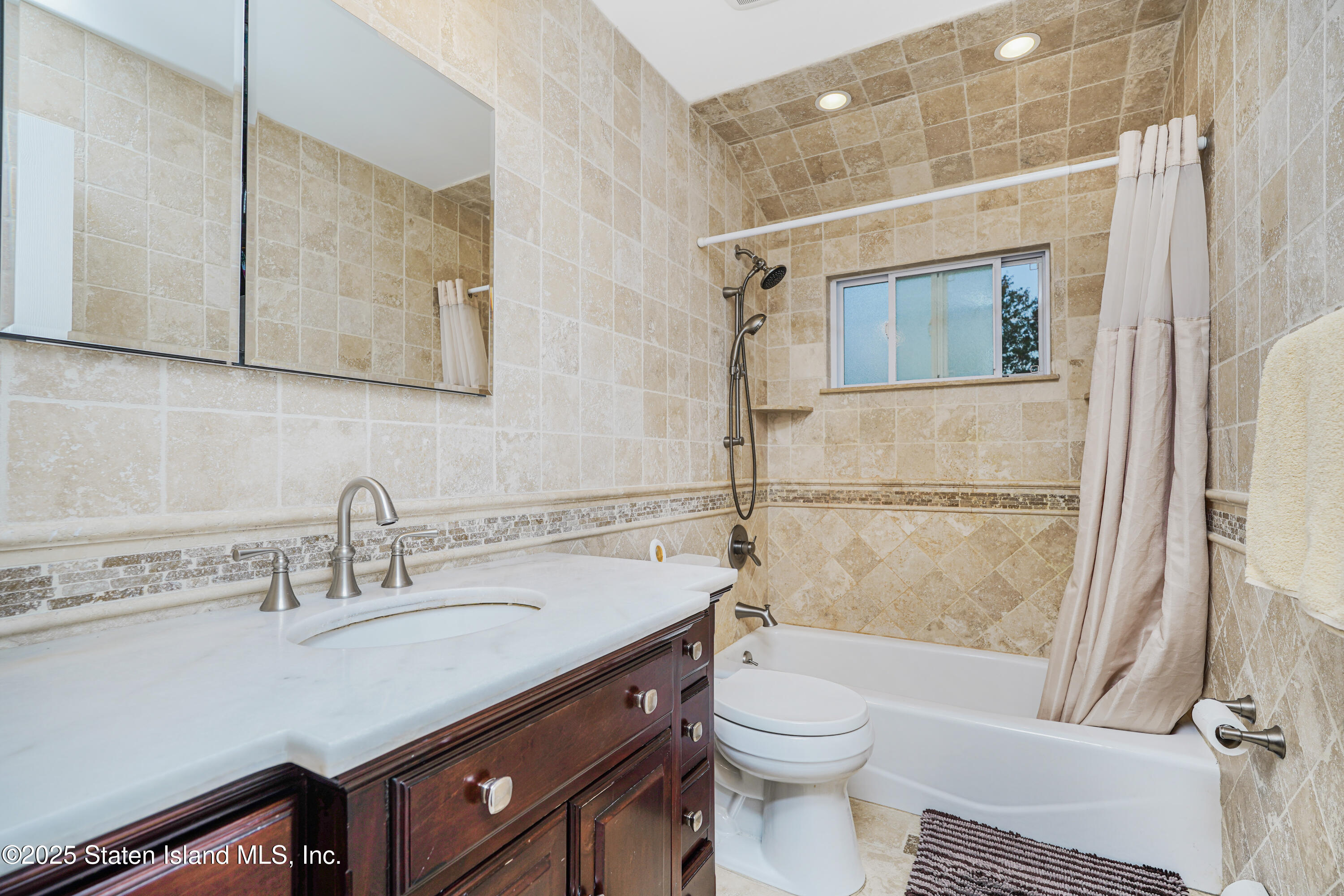 145 Shirley Avenue Staten Island, NY 10312 - Photo 20 of 29 a bathroom with a sink a toilet and shower