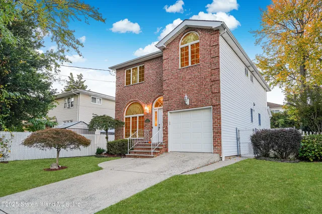 a front view of house with yard and green space