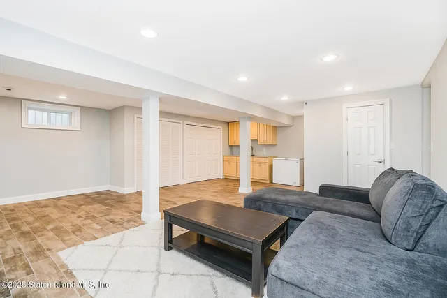 a living room with furniture rug and window
