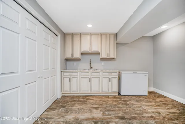 a kitchen with granite countertop white cabinets and white appliances