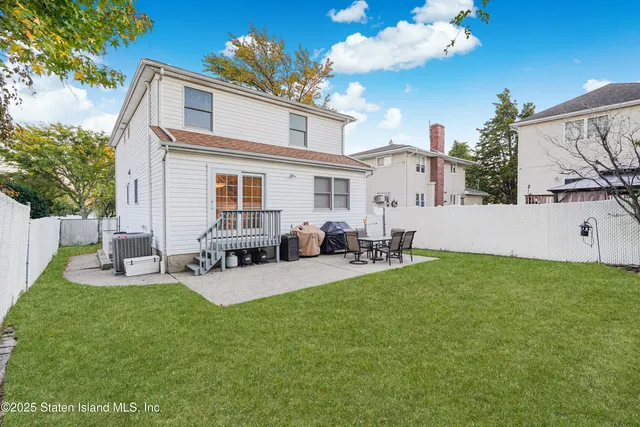 a view of a house with backyard sitting area and garden