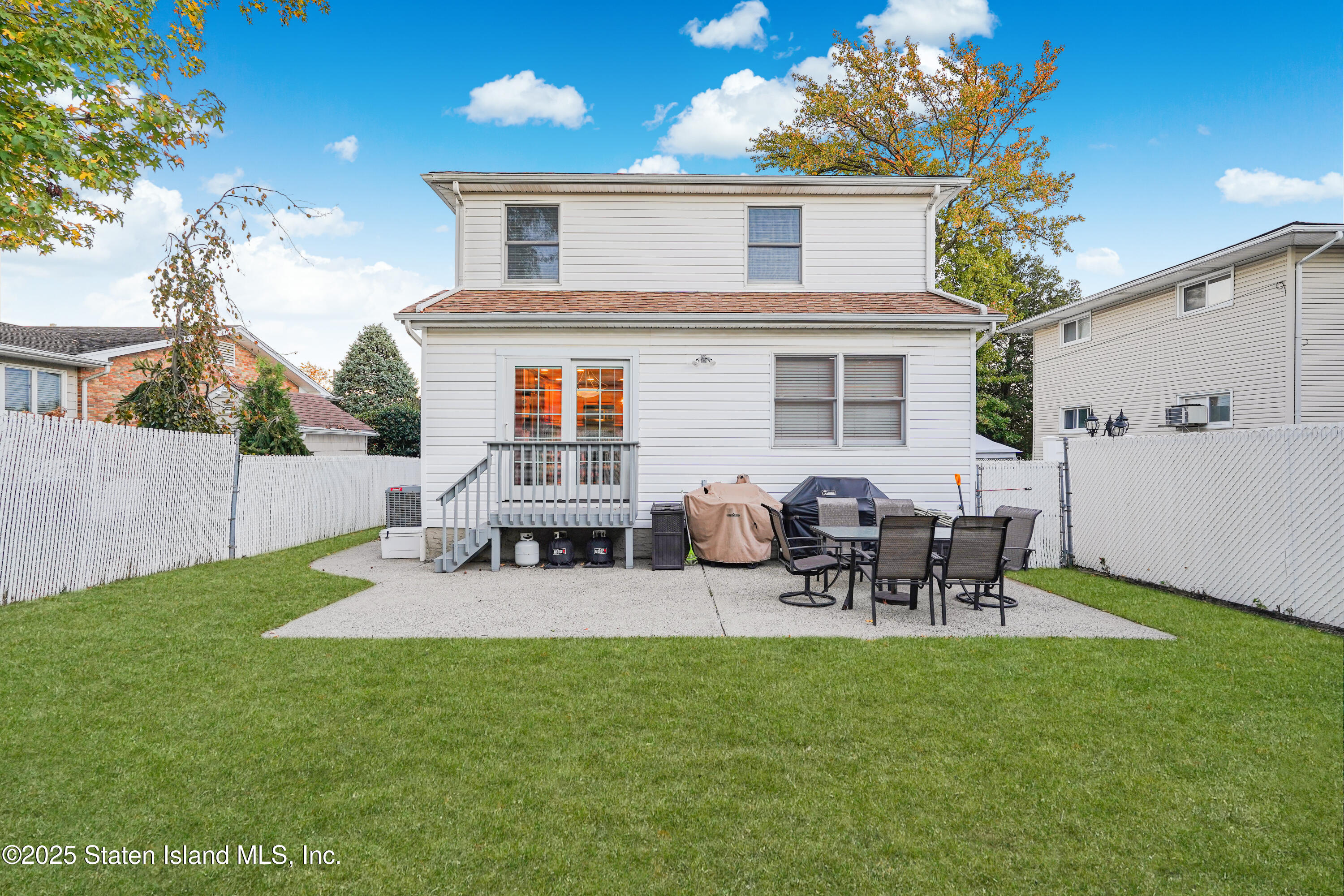 145 Shirley Avenue Staten Island, NY 10312 - Photo 29 of 29 a view of a patio with table and chairs potted plants and large tree