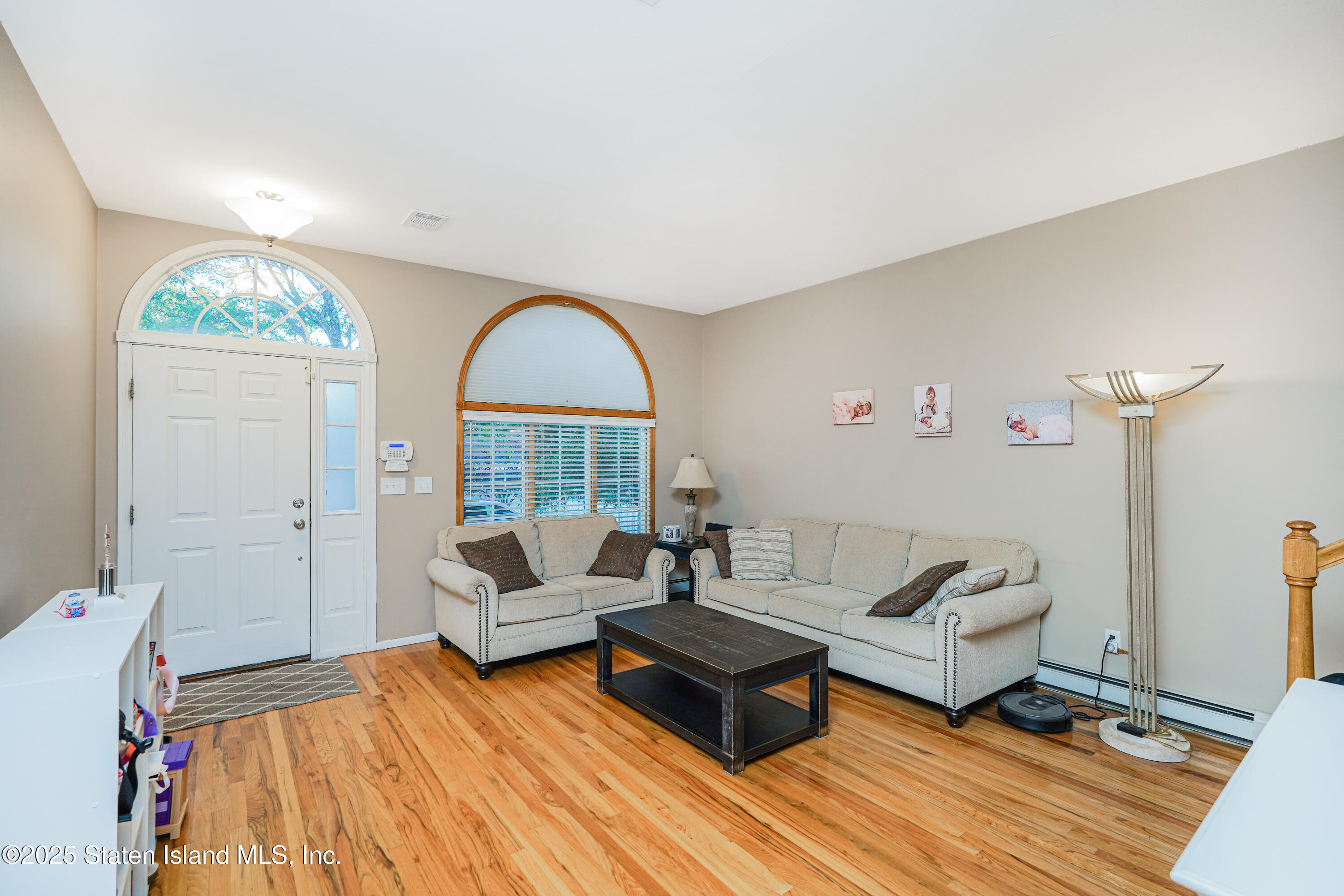 145 Shirley Avenue Staten Island, NY 10312 - Photo 3 of 29 a living room with furniture and a wooden floor
